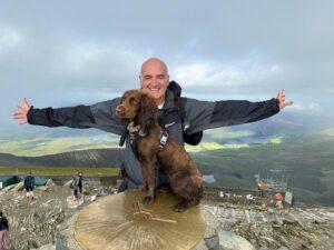 Tullis and Dog Gem on top of a mountain